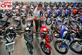 File Photo: A worker cleans a Bajaj motorcycle at a Bajaj Auto showroom in Kolkata, India.
Image: REUTERS/Rupak De Chowdhuri /File Photo