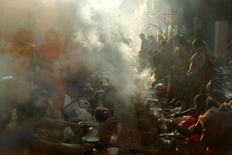 Devotees cook a sweet rice dish as an offering to the Sun God during Pongal celebrations, also known as Makar Sankranti, on a street in Mumbai, India, on January 15, 2024.