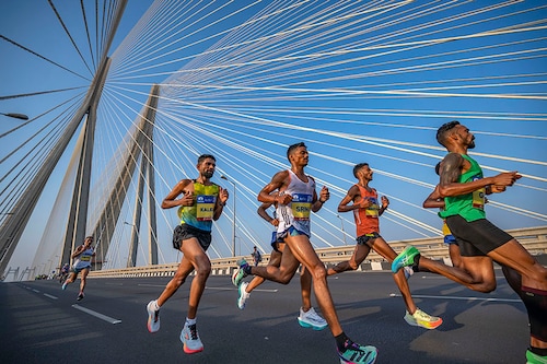Athletes run on Bandra-Worli sea link bridge as they take part in a marathon on January 21, 2024 in Mumbai, India.
Image: Satish Bate/Hindustan Times via Getty Images