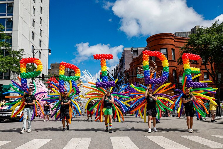 Participants carrying balloons spelling out "Pride" during the 53rd annual Chicago Pride Parade on June 30, 2024, in Chicago, Illinois.