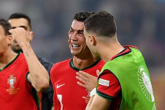 Cristiano Ronaldo of Portugal looks dejected as he is consoled by teammates ahead of the second half of extra-time during the UEFA EURO 2024 round of 16 match between Portugal and Slovenia at Frankfurt Arena on July 01, 2024 in Frankfurt am Main, Germany.