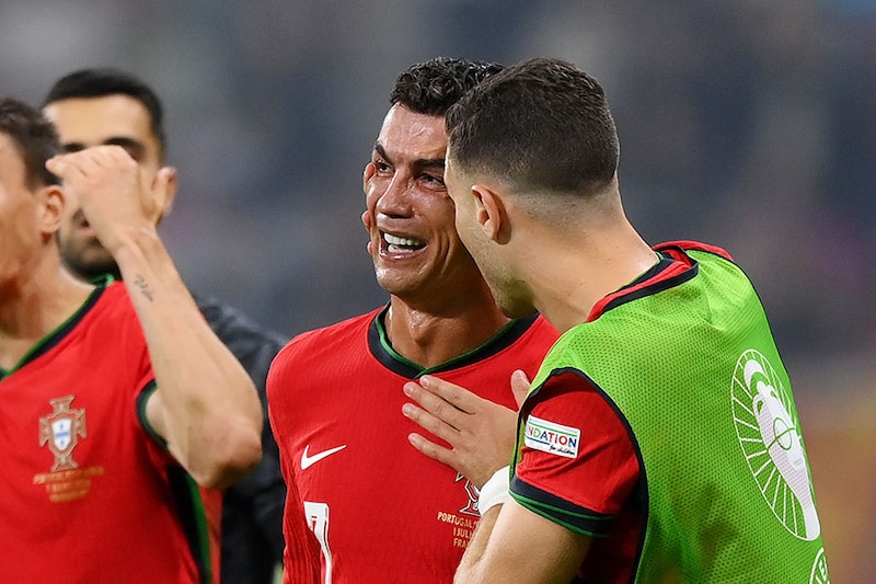 Cristiano Ronaldo of Portugal looks dejected as he is consoled by teammates ahead of the second half of extra-time during the UEFA EURO 2024 round of 16 match between Portugal and Slovenia at Frankfurt Arena on July 01, 2024 in Frankfurt am Main, Germany.