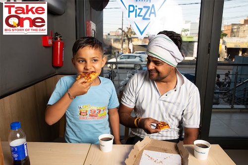 Manoj Sisodia treats his nephew Honey Rawal to a quick pizza at Domino"s Dadri Image: Madhu Kapparath