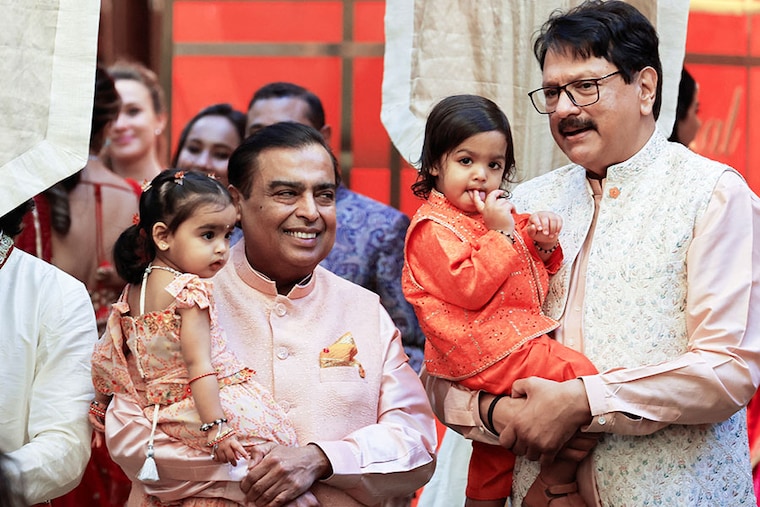 Indian businessmen Mukesh Ambani and Ajay Piramal pose for a picture with their grandchildren during the pre-wedding ceremony of Mukesh Ambani"s son Anant Ambani and Radhika Merchant, at Ambani"s residence in Mumbai, India, on July 3, 2024.