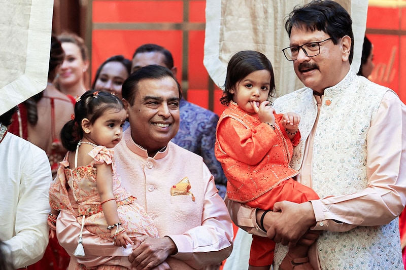 Indian businessmen Mukesh Ambani and Ajay Piramal pose for a picture with their grandchildren during the pre-wedding ceremony of Mukesh Ambani"s son Anant Ambani and Radhika Merchant, at Ambani"s residence in Mumbai, India, on July 3, 2024.