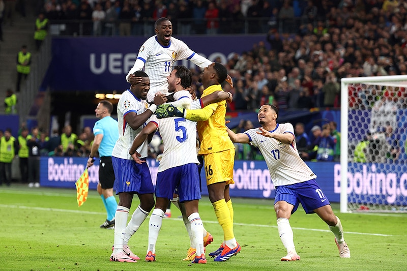 France"s players celebrate after winning the UEFA Euro 2024 quarter-final football match between Portugal and France at the Volksparkstadion in Hamburg on July 5, 2024.