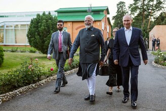 In this pool photograph distributed by the Russian state agency Sputnik, Russia"s President Vladimir Putin and Indian Prime Minister Narendra Modi take a walk during an informal meeting at the Novo-Ogaryovo state residence, outside Moscow, on July 8, 2024.