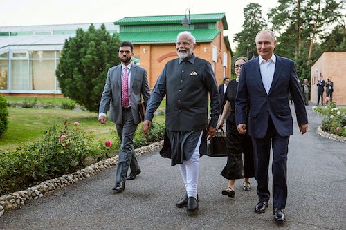In this pool photograph distributed by the Russian state agency Sputnik, Russia"s President Vladimir Putin and Indian Prime Minister Narendra Modi take a walk during an informal meeting at the Novo-Ogaryovo state residence, outside Moscow, on July 8, 2024.