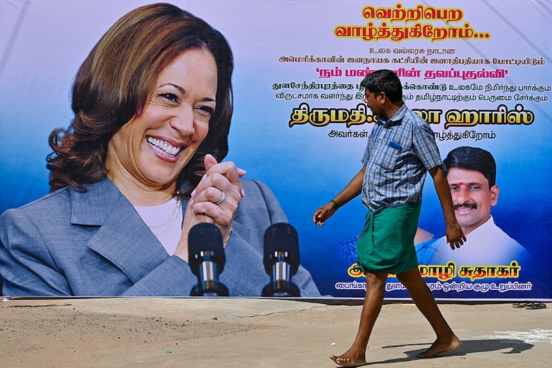 A man walks past a poster of US Vice President Kamala Harris in her ancestral village of Thulasendrapuram in the south Indian state of Tamil Nadu on July 23, 2024, after she was endorsed for the US presidential election.