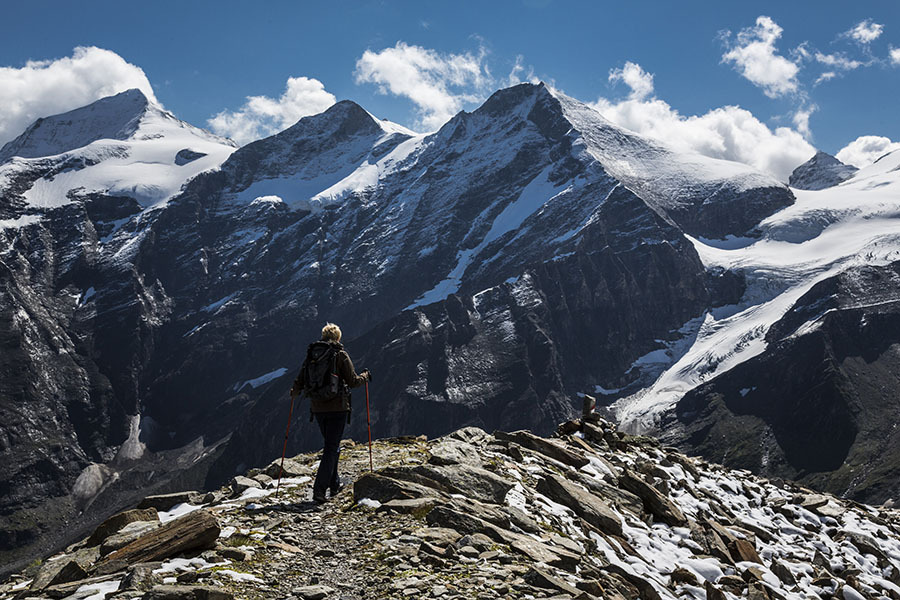 Young trekker on a hiking trail passing a snow-capped massif in the Australian, in Mooserboden, Austria. Photo: Thomas Trutschel/Photothek via Getty Images