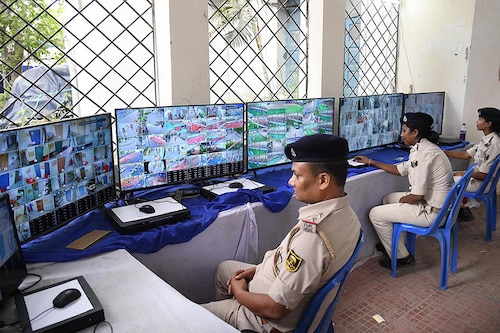 Police personnel watch CCTV footage to monitor the strong room where Electronic Voting Machines (EVMs) were kept after the seventh and last phase of the Lok Sabha election at AN College on June 2, 2024, in Patna, India.