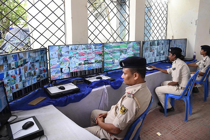 Police personnel watch CCTV footage to monitor the strong room where Electronic Voting Machines (EVMs) were kept after the seventh and last phase of the Lok Sabha election at AN College on June 2, 2024, in Patna, India.
