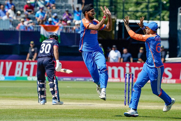 India"s Arshdeep Singh celebrates a successful lbw with teammate Suryakumar Yadav (R) during the ICC men"s Twenty20 World Cup 2024 group A cricket match between the USA and India at Nassau County International Cricket Stadium in East Meadow, New York, on June 12, 2024.