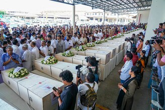 Relatives mourn near the deceased after the coffins" arrival on an Indian Air Force plane from Kuwait at the Cochin International Airport in Kochi on June 14, 2024. Grieving families kept a solemn vigil in the terminal of an Indian airport on June 14 as the bodies of dozens of migrant workers killed in a Kuwait building fire returned home. Wednesday"s dawn blaze quickly engulfed a housing block home to some of the many foreign labourers servicing the oil-rich gulf state"s economy.