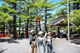 People visit the Komitake shrine near the Fuji Subaru Line 5th station, which leads to the popular Yoshida trail for hikers climbing Mount Fuji at Narusawa, Yamanashi Prefecture, on June 19, 2024. AFP_JapanTourismFuji. Image: PHILIP FONGAFP