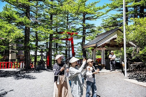 People visit the Komitake shrine near the Fuji Subaru Line 5th station, which leads to the popular Yoshida trail for hikers climbing Mount Fuji at Narusawa, Yamanashi Prefecture, on June 19, 2024. AFP_JapanTourismFuji. Image: PHILIP FONGAFP