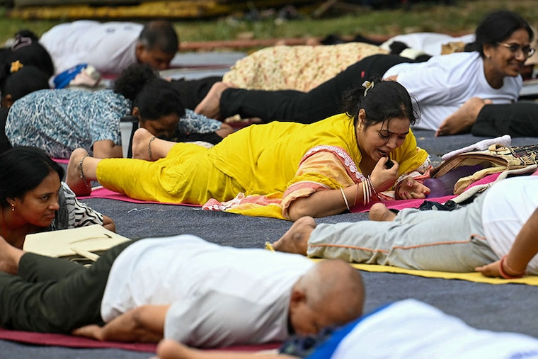 People take part in a yoga session at Lodhi Gardens on International Day of Yoga in New Delhi on June 21, 2024.