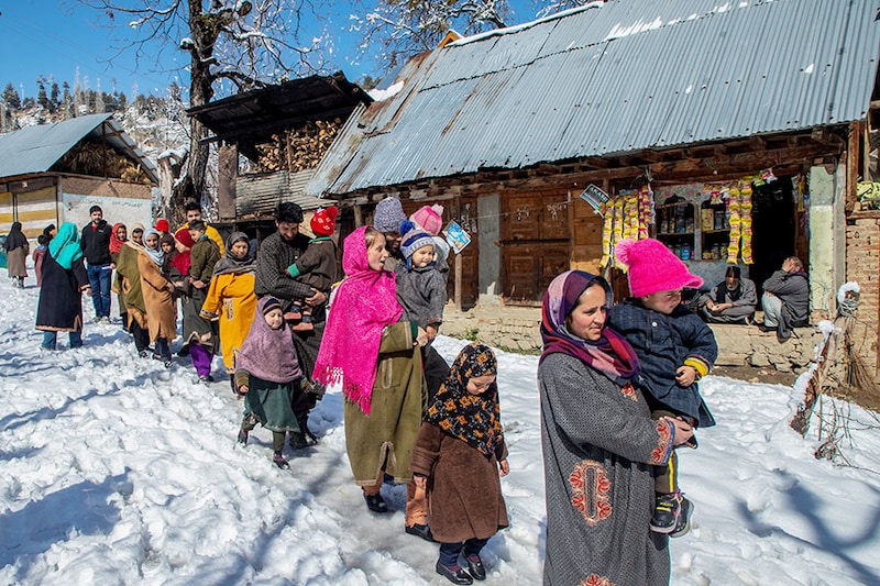 Parents carrying their children queue along a snow-covered road outside the health centre to receive a dose of polio vaccine drops during a nationwide Pulse Polio Immunisation (PPI) drive in a remote village in Budgam. Over 1.9 million children under five will receive the oral polio vaccine on March 3 across 11,000 booths, with vaccines dispatched to snow-affected areas through choppers in Jammu and Kashmir. Senior health officials told local media that about 45,000 healthcare workers would be involved in the process to ensure no child was left behind. India rolled out the Pulse Polio Immunisation Programme on October 2, 1994, when the country accounted for around 60 percent of the global polio cases. Within two decades, India received "polio-free certification" from the World Health Organisation, along with the entire Southeast Asia Region, on March 27, 2014, with the last polio case being reported in Howrah, in eastern India"s West Bengal state, on January 13, 2011. India conducts one nationwide and two sub-national vaccination days for polio every year to maintain population immunity against wild poliovirus and to sustain its polio-free status.