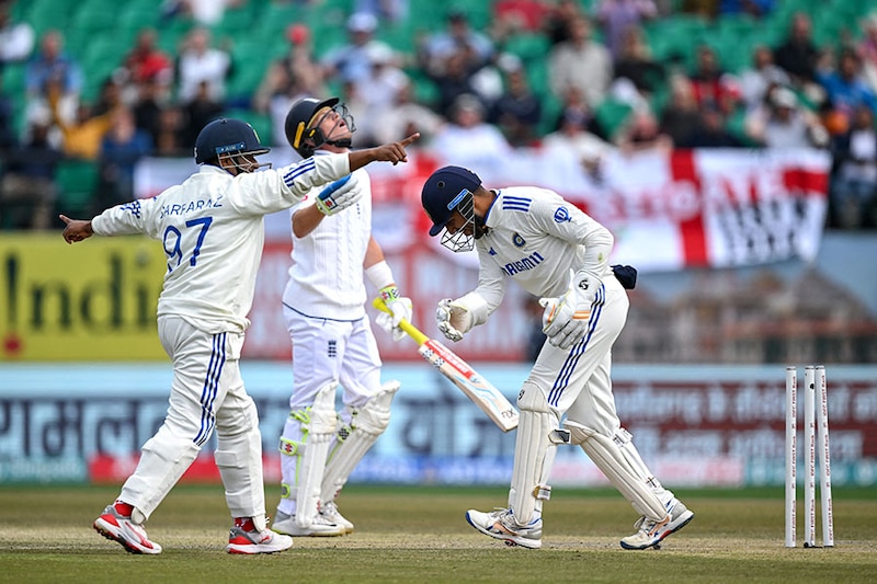 India"s Dhruv Jurel (R) celebrates with his teammate Sarfaraz Khan after he stumps out England"s Ollie Pope (C) during the first day of the fifth and last Test cricket match between India and England at the Himachal Pradesh Cricket Association Stadium in Dharamsala on March 7, 2024.