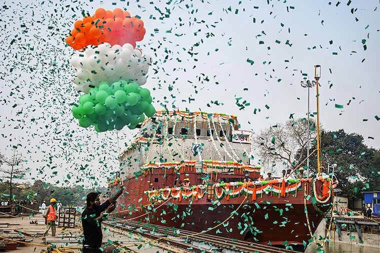 Employees of Garden Reach Shipbuilders and Engineers (GRSE) celebrate the launch of the Anti-Submarine Warfare Shallow Water Craft (ASW-SWC) corvette at the GRSE dockyard in Kolkata on March 13, 2024.