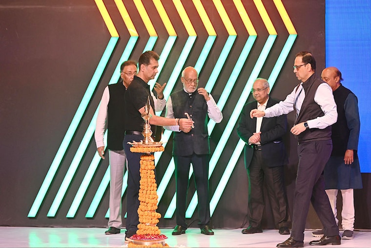 Rajiv Bajaj offers the candle to Sanjiv Bajaj to light a diya before announcing the launch of Bajaj Beyond, a CSR initiative committing Rs5,000 crore in five years, impacting around two crore people with a focus on skilling. Seen here are other Bajaj family members including Shekhar Bajaj and Niraj Bajaj on March 22, 2024, in Pune, India.