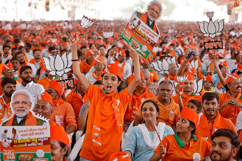 Supporters hold cut-outs of Lotus, the symbol of Bharatiya Janata Party (BJP) and India"s Prime Minister Narendra Modi, during an election campaign rally in Anand, India, May 2, 2024.