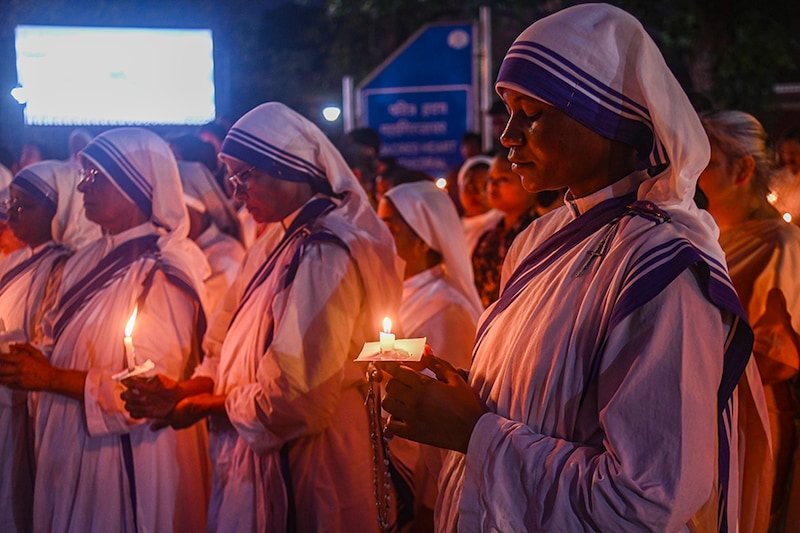 Indian Christian nuns pray during a candlelight vigil outside a church to mark the one-year anniversary of the violent clashes that began on May 3, 2023, between the Meiteis and the Kuki-Zo ethnic groups in the northeastern state of Manipur, in New Delhi, India. Image: Kabir Jhangiani/NurPhoto via Getty Images