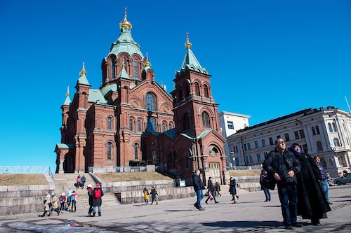 Tourists take photographs in front of Russian Orthodox Uspenski Cathedral on March 30, 2018 in Helsinki, Finland. Image credit: Chris J Ratcliffe/Getty Images