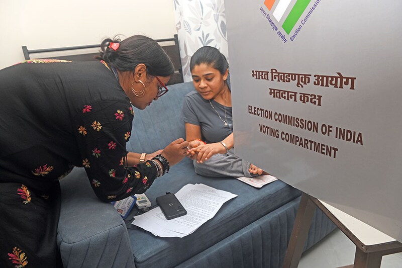 A physically disabled voter"s finger is marked with indelible ink during an electoral official home visit in Mumbai, India, on Sunday, May 12, 2024. This week saw as many as 172 million eligible Indians going to the polls in phase three of the country"s marathon seven-phase election, which runs through June 1.