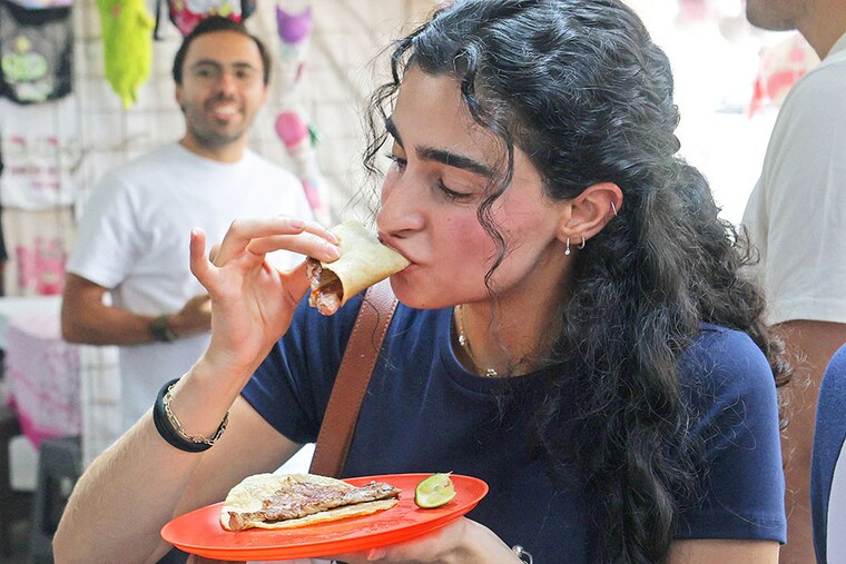 A woman eats tacos at Taqueria restaurant El Califa de Leon in Mexico City on May 15, 2024. Image credit: Photography Silvana FLORES / AFPÂ©