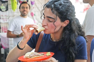 A woman eats tacos at Taqueria restaurant El Califa de Leon in Mexico City on May 15, 2024. Image credit: Photography Silvana FLORES / AFP©