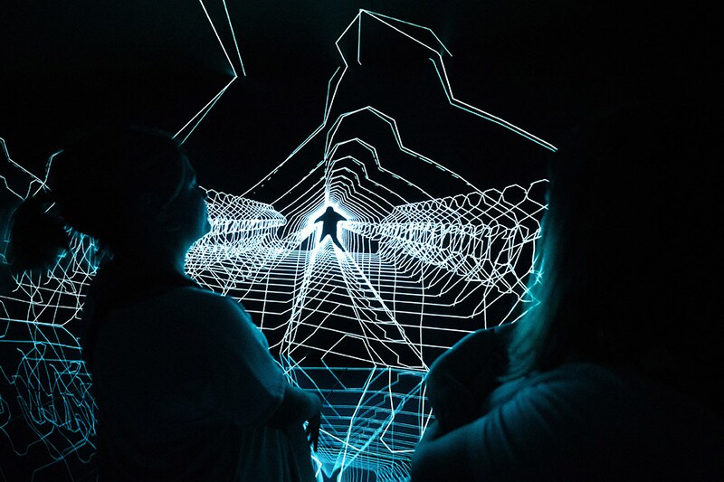 People enjoy "Music:Response" experimental audiovisual installation by The Chemical Brothers and Smith & Lyall during the opening of The Cube audiovisual space at Casa Batllo in Barcelona on May 24, 2024. Image: Josep Lago / AFP