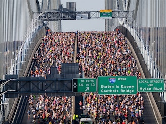 In this aerial view, runners compete as they cross over the Verrazzano-Narrows Bridge during the 2024 TCS New York City Marathon on November 03, 2024, in New York City.