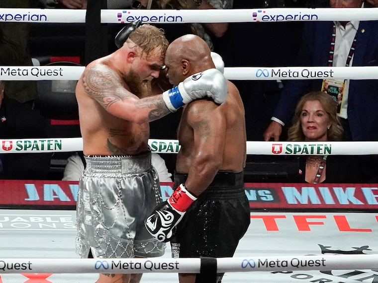 US retired pro-boxer Mike Tyson (R) and US YouTuber/boxer Jake Paul (L) hug after Paul defeated Tyson in their heavyweight boxing bout at The Pavilion at AT&T Stadium in Arlington, Texas, November 15, 2024.