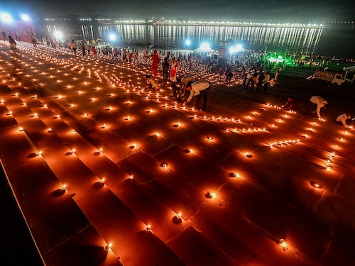 Devotees light traditional oil lamps as they celebrate the Hindu festival of "Dev Deepawali" at Sangam, the confluence of the rivers Ganges, Yamuna and mythical Saraswati in Prayagraj on November 15, 2024.