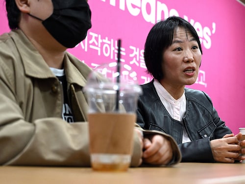 On Ji-goo (L), who wanted to use her pen name and declined to reveal her face for security reasons, and Jung Yun-jung (R), an activist who supported On throughout her trials
Image: Jung Yeon-je / AFP