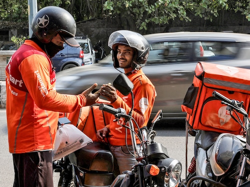 Gig workers prepare to deliver orders outside Swiggy"s grocery warehouse at a market area in New Delhi, India.
Image: Reuters/Priyanshu Singh Gig workers prepare to deliver orders outside Swiggy"s grocery warehouse at a market area in New Delhi, India.
Image: Reuters/Priyanshu Singh