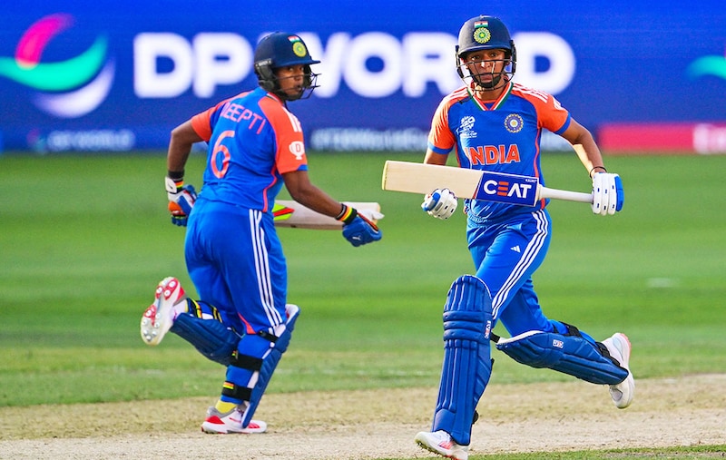 India"s captain Harmanpreet Kaur (R) and her teammate Deepti Sharma take a run during the ICC Women"s T20 World Cup cricket match between Pakistan and India at the Dubai International Cricket Stadium in Dubai on October 6, 2024. India beat Pakistan by six wickets.