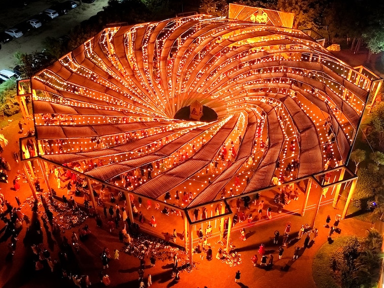 An aerial view shows revellers wearing traditional clothes as they dance at a Garba during the Hindu festival of Navaratri, in the outskirts of Ahmedabad on October 9, 2024.