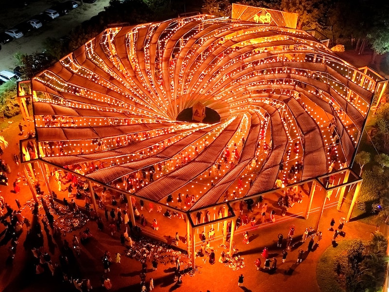 An aerial view shows revellers wearing traditional clothes as they dance at a Garba during the Hindu festival of Navaratri, in the outskirts of Ahmedabad on October 9, 2024.