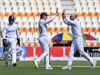 England"s captain Ollie Pope (C) celebrates with teammate Jack Leach (R) after winning the first Test cricket match between Pakistan and England at the Multan Cricket Stadium in Pakistan"s Multan on October 11, 2024. Spinner Leach grabbed four wickets to help England beat Pakistan taking a 1-0 lead in the three-match series.