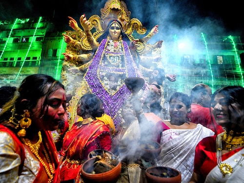 Hindu women devotees perform dhunuchi dance on the occasion of Durga Puja immersion. Durga Puja, an annual festival that marks victory of good over evil is celebrated by Hindus all over India & abroad. It is an occasion of great enthusiasm and festivity for the Hindus. On the last day, the day of Bhashan or Vijoya Dashami images and idols are immersed in water.