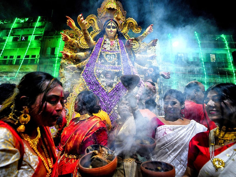 Hindu women devotees perform dhunuchi dance on the occasion of Durga Puja immersion. Durga Puja, an annual festival that marks victory of good over evil is celebrated by Hindus all over India & abroad. It is an occasion of great enthusiasm and festivity for the Hindus. On the last day, the day of Bhashan or Vijoya Dashami images and idols are immersed in water.