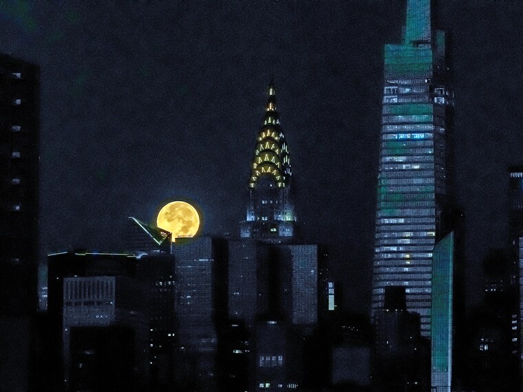 The Hunter"s Supermoon sets over Manhattan behind an Art Deco skyscraper, the Chrysler Building, in New York City, United States, on October 17, 2024.