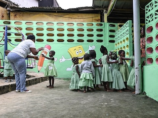 A teacher interacts with children at the Angre Cocovico market nursery and daycare in Abidjan.
Image: Issouf Sanogo / AFP©