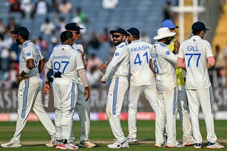 India"s players celebrate after the dismissal of New Zealand"s captain Tom Latham during the second day of the second Test cricket match between India and New Zealand at the Maharashtra Cricket Association Stadium in Pune on October 25, 2024.