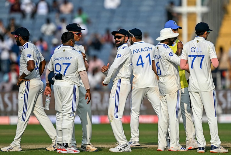 India"s players celebrate after the dismissal of New Zealand"s captain Tom Latham during the second day of the second Test cricket match between India and New Zealand at the Maharashtra Cricket Association Stadium in Pune on October 25, 2024.