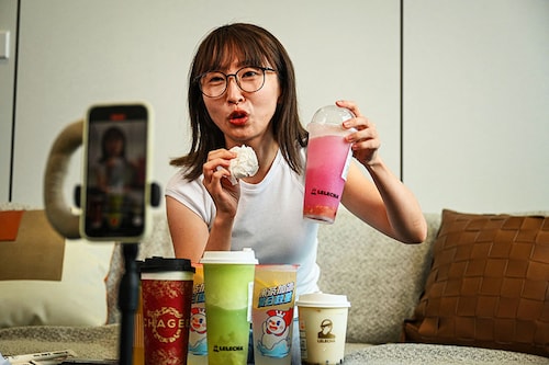 Bubble tea vlogger Stacy Chen recording footage for her vlog at her company in Hangzhou, in eastern China"s Zhejiang province.
Image: Jade Gao / AFPÂ©