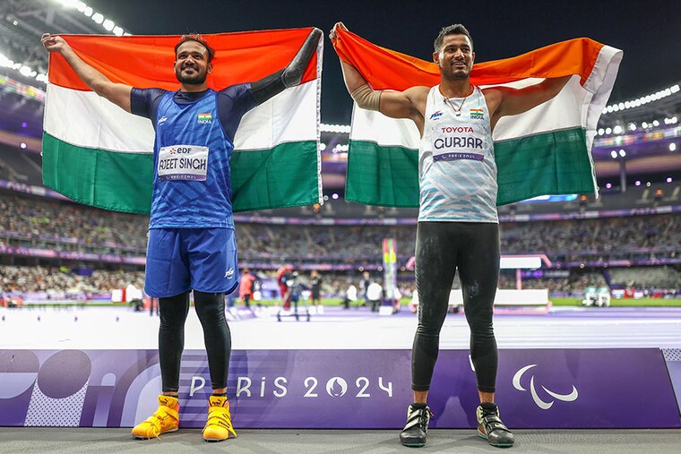 Silver medallist Ajeet Singh (L) and Bronze medallist Sundar Singh Gurjar of Team India pose for a photo with Indian flags after competing during the Men"s Javelin Throw F46 Final on day six of the Paris 2024 Summer Paralympic Games at Stade de France on September 03, 2024 in Paris, France. Image: Naomi Baker/Getty Images