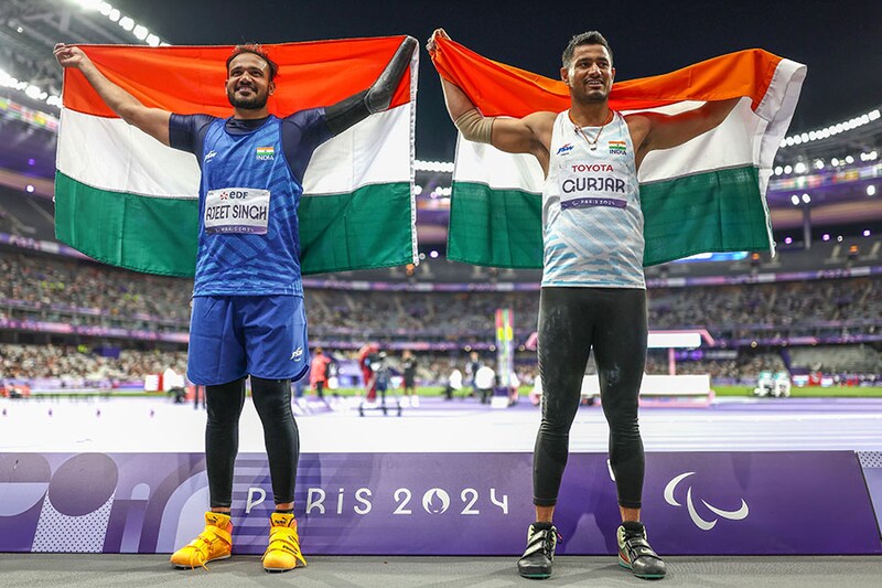 Silver medallist Ajeet Singh (L) and Bronze medallist Sundar Singh Gurjar of Team India pose for a photo with Indian flags after competing during the Men"s Javelin Throw F46 Final on day six of the Paris 2024 Summer Paralympic Games at Stade de France on September 03, 2024 in Paris, France. Image: Naomi Baker/Getty Images